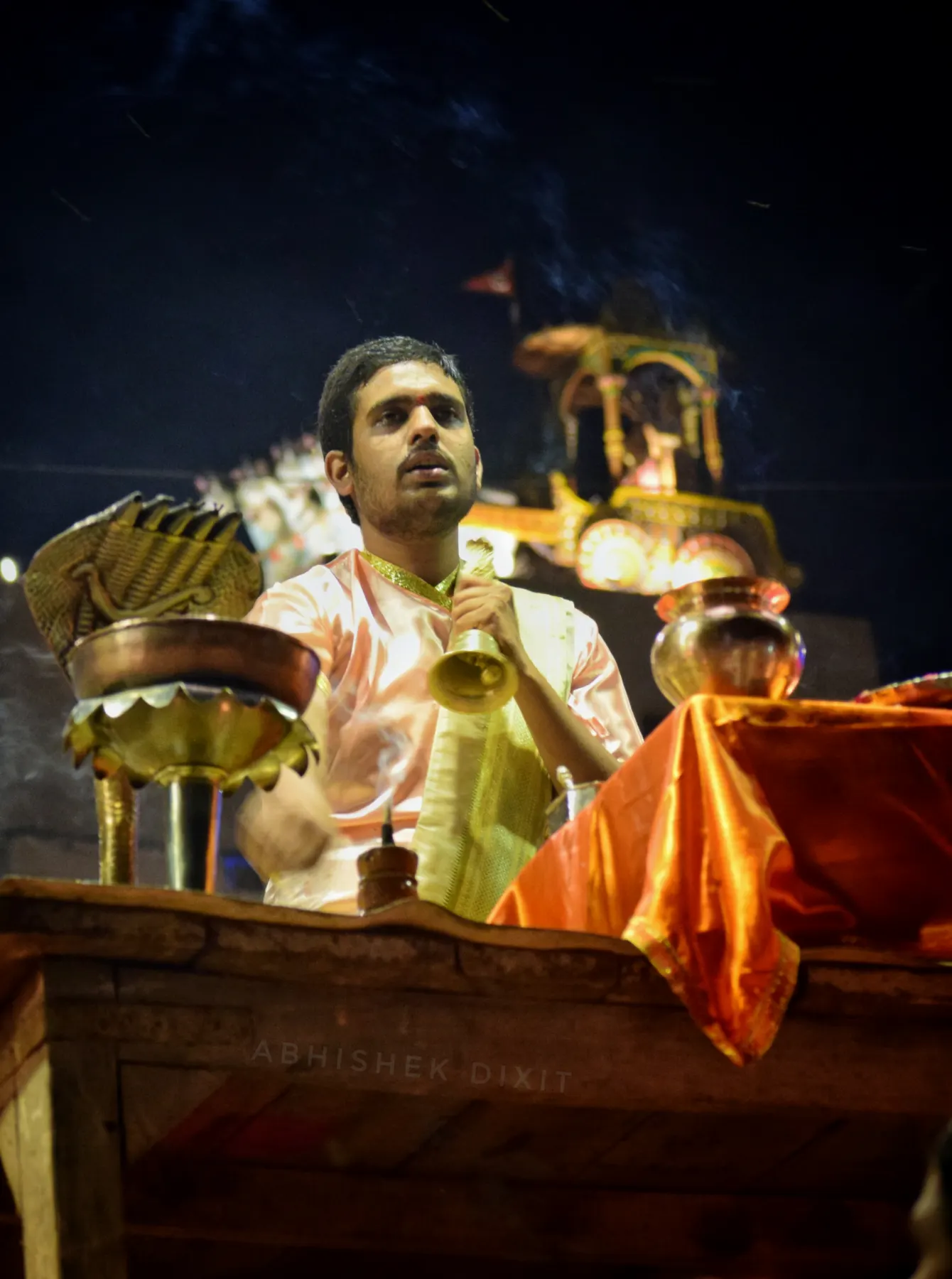 A priest ringing a bell at the Ganga Aarti