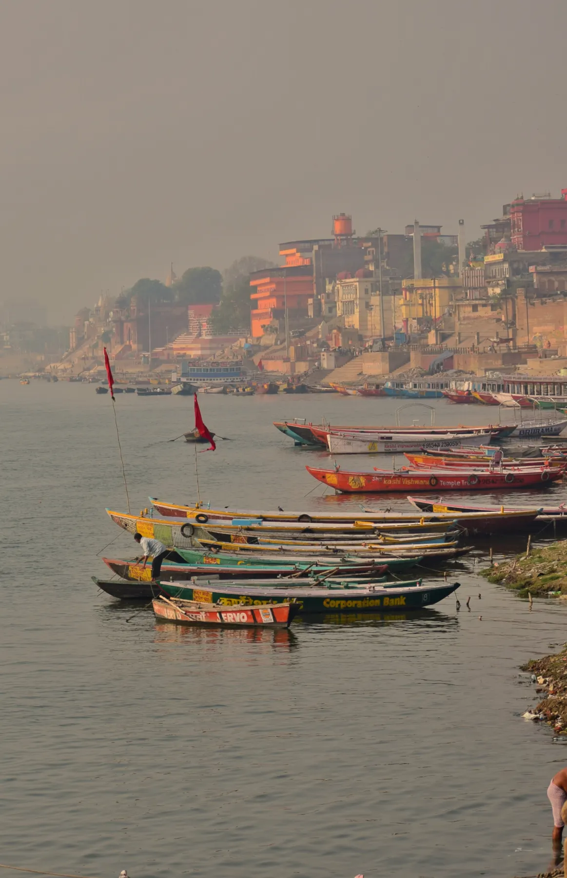 Colourful boats and ghats in the winter mist